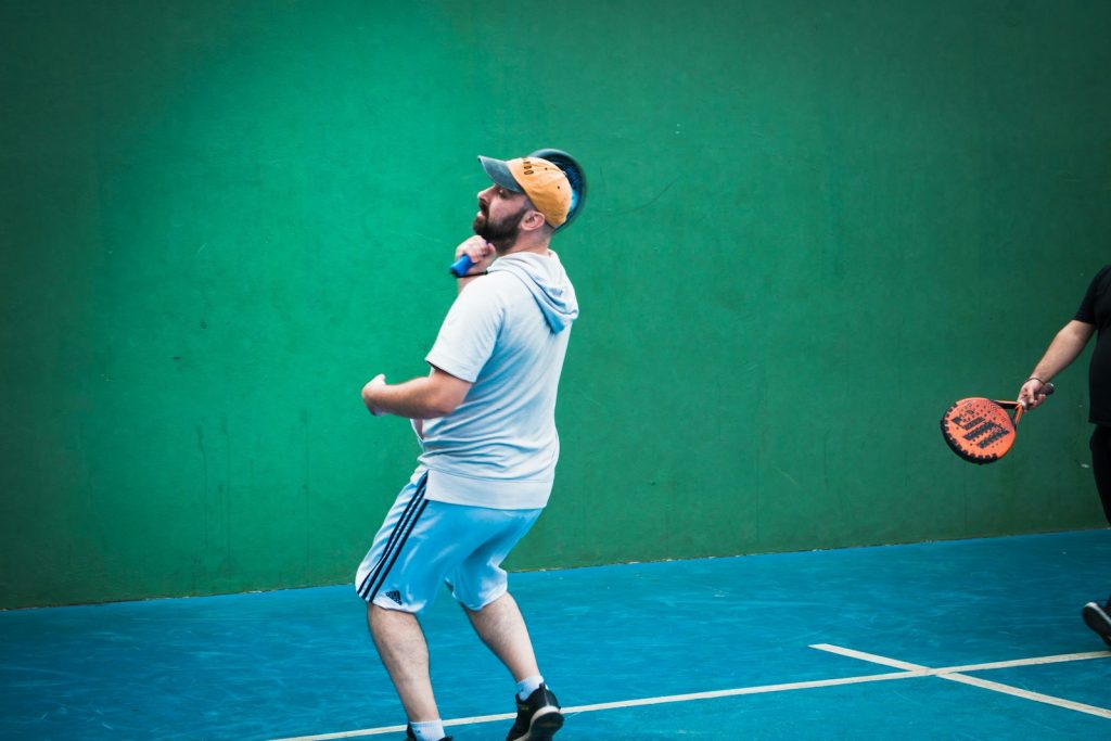 a man standing on a tennis court holding a racquet