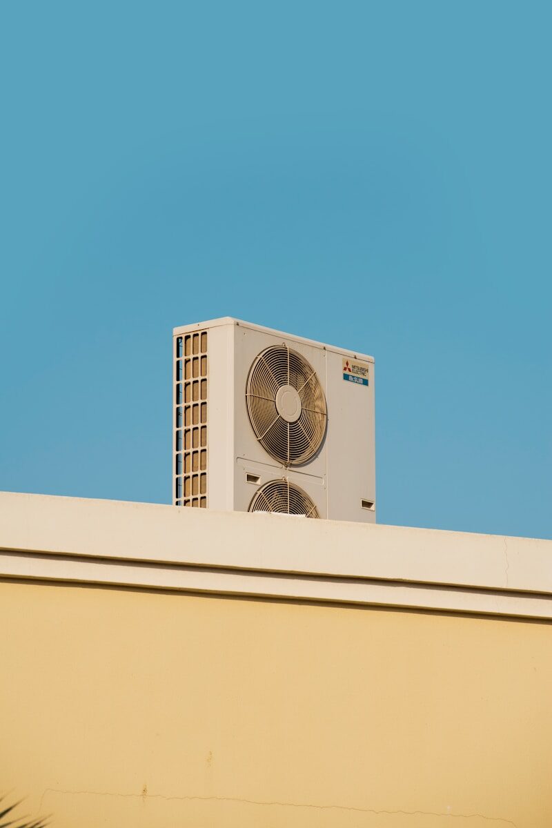 a white air conditioner sitting on top of a building